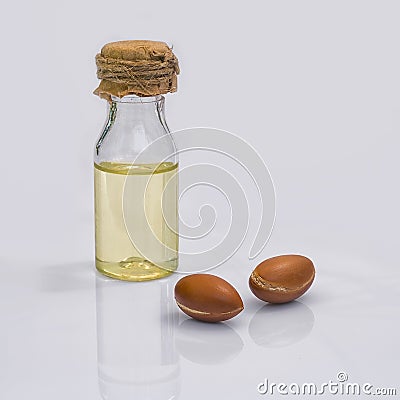 Argan fruit (Argania spinosa), nuts and oil on white background Stock Photo