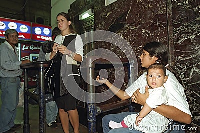 Portrait of begging mother with baby on train station Editorial Stock Photo