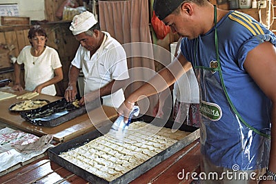 Argentinean bakers bake bread and pastry in bakery Editorial Stock Photo