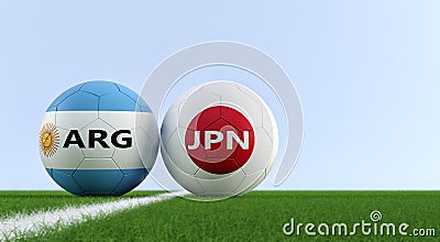 Argentina vs. Japan Soccer Match - Soccer balls in Argentina and Japan national colors on a soccer field. Stock Photo