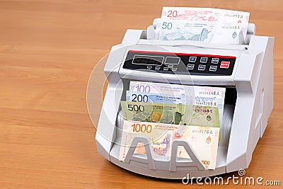 Argentine peso in a counting machine Stock Photo