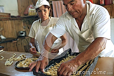 Argentinean bakers bake bread in bakery Editorial Stock Photo