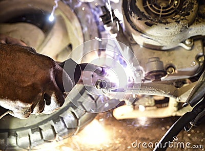 Argon welding to the motorcycle underside Stock Photo