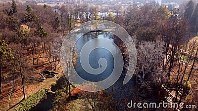 Arial drone view flight over lake in park on sunny autumn day Stock Photo