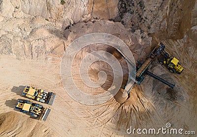 Arial view of the sand open-pit mining with heavy mining machinery. Mobile stone jaw crusher machine in open pit mine. Wheel Stock Photo