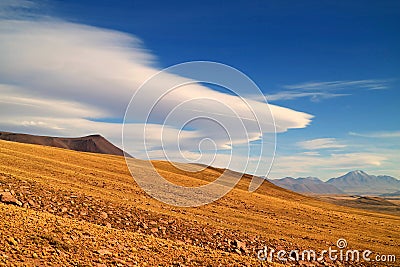 The Arid Foothill of Los Flamencos National Reserve with the Amazing Lenticular Clouds in the Backdrop, Chilean Altiplano Stock Photo