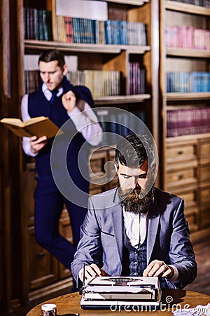 Aristocracy and education concept. Man with beard typing on typewriter Stock Photo