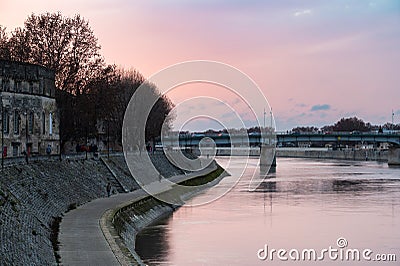 Arles, Provence, France, Promenade at the banks of the River Rhone during a colorful sunset Editorial Stock Photo