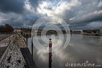 Arles, Provence, France, View from the banks of the River Rhone with a promenade and dark rainy clouds Editorial Stock Photo