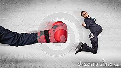 Arm with boxing gloves hits office worker concept Stock Photo