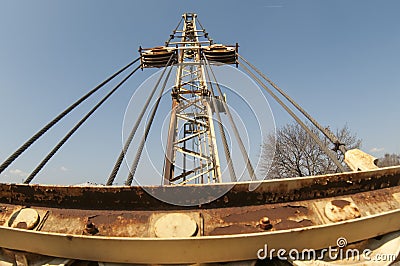 Arm of crane. Yellow boom of an old crane on a blue sky background. Stock Photo