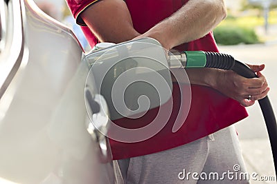 Arm of men at a gas station Stock Photo