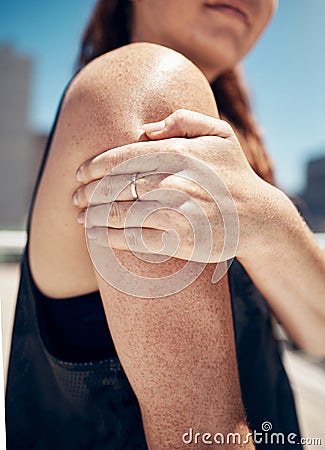 Arm, shoulder and exercise woman injury, athlete training, and fitness workout in outdoor urban city. Closeup joint pain Stock Photo