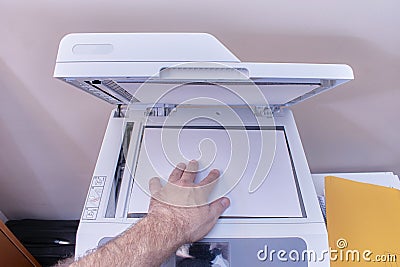 Arm of a white or caucasian man making a photocopy on a photocopier in the office Stock Photo