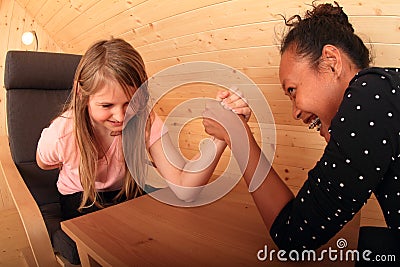 Arm wrestling - laughing girls Stock Photo