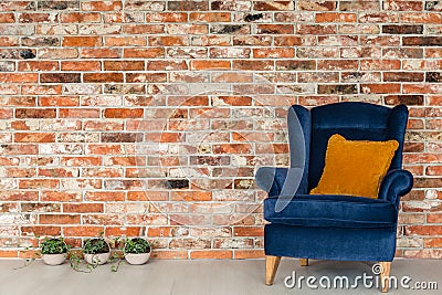 Armchair with orange pillows Stock Photo