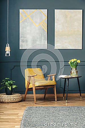 Armchair between plant and table Stock Photo