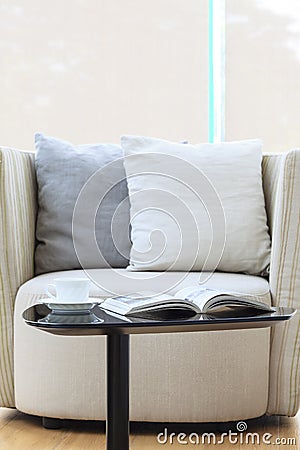 Armchair sofa with pillows coffee and book home interior Stock Photo