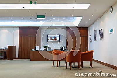 Armchairs, table and reception in office Stock Photo