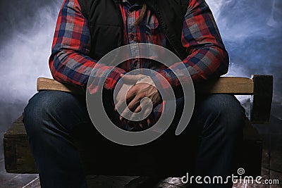 Armed axeman in atmospheric smoke. Dangerous male Stock Photo