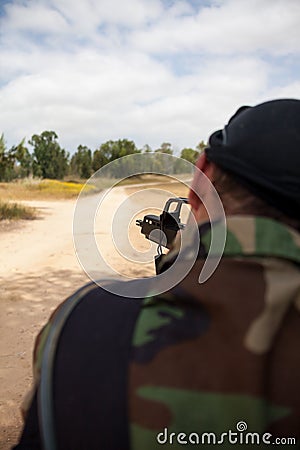 Armed man with a gun is holding at gunpoint Stock Photo