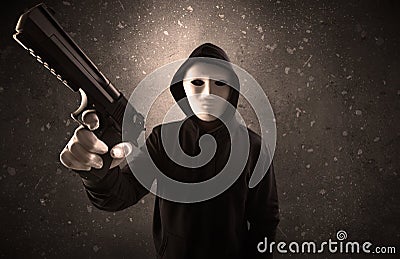 Armed villain in an empty dark room Stock Photo