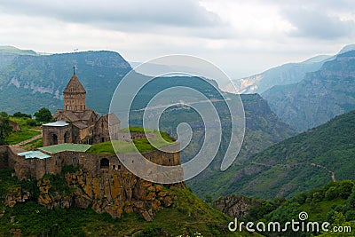 Armenia`s landmark Tatev Monastery on a cliff of a cliff against the backdrop of high picturesque Stock Photo