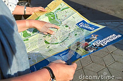 Armenia, Yerevan - June 12, 2017. Russian female tourists using a paper map on Yerevan street Editorial Stock Photo