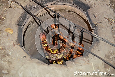 Armenian barbeque in tonir tandoor stone oven. Stock Photo