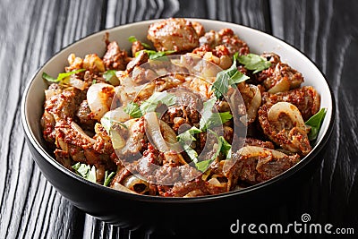 Armenian cuisine recipe chicken liver, heart and stomachs with onions, tomatoes and spices close-up in a bowl. horizontal Stock Photo