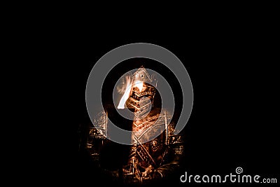 Armored Knight in dark with Torch Stock Photo