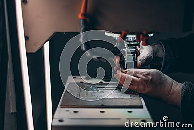 Arms of worker changing tool in CNC milling machine Stock Photo