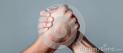 Arms wrestling. Closep up. Friendly handshake, friends greeting, teamwork, friendship. Handshake, arms, friendship. Man Stock Photo