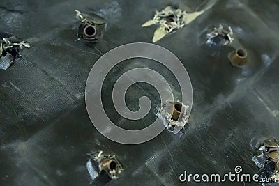 Army background. Bulletproof test armor protection armor assault rifles stuck in the plate base grunge Stock Photo