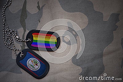 army blank, dog tag with flag of belize and gay rainbow flag on the khaki texture background. Stock Photo