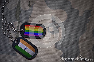 army blank, dog tag with flag of india and gay rainbow flag on the khaki texture background. Stock Photo