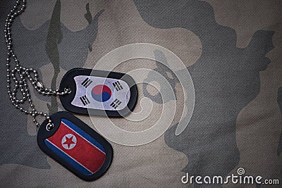 army blank, dog tag with flag of south korea and north korea on the khaki texture background. Stock Photo