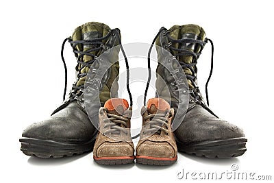 Army boots and children's shoes Stock Photo