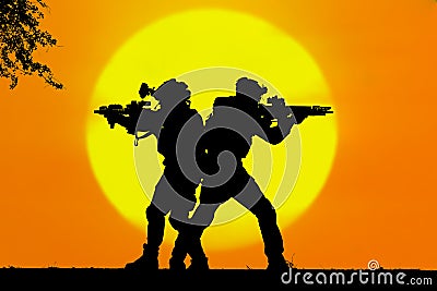 Army soldier with rifle orange sunset silhouette Stock Photo