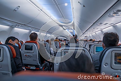 High angle of air passengers with protective masks sitting on their seats in Turkish Airlines flight before flying Editorial Stock Photo