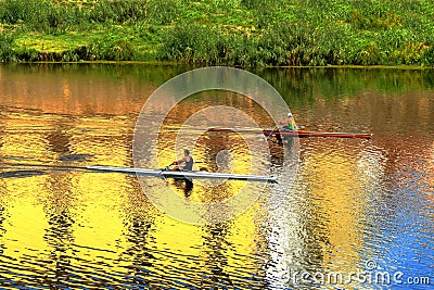 Arno River and two rowers on a boats. Florence, Italy. Editorial Stock Photo