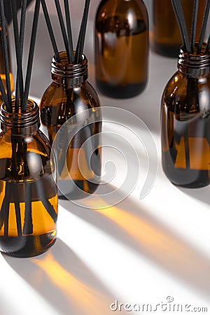 Aroma diffuser with essential oil in a Amber, brown glass bottle. Creative trendy image, Caustics formed by the refraction of the Stock Photo