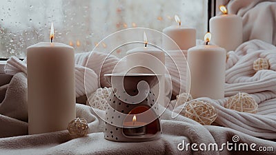 Aroma lamp with essential oil, aromatherapy at home, burning candle, dropping essential oil. Concept of home relaxation Stock Photo