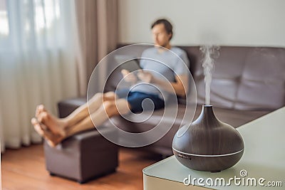 Aromatherapy Concept. Wooden Electric Ultrasonic Essential Oil Aroma Diffuser and Humidifier. Ultrasonic aroma diffuser Stock Photo