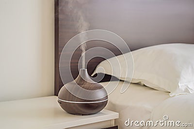 Aromatherapy Concept. Wooden Electric Ultrasonic Essential Oil Aroma Diffuser and Humidifier. Ultrasonic aroma diffuser Stock Photo