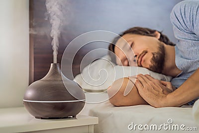 Aromatherapy Concept. Wooden Electric Ultrasonic Essential Oil Aroma Diffuser and Humidifier. Ultrasonic aroma diffuser Stock Photo