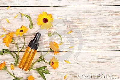 Aromatherapy essential oil with marigold flowers on white background with copy space for your text. Top view Stock Photo