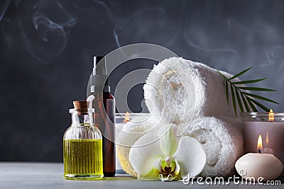 Aromatherapy, spa, beauty treatment and wellness background with massage oil, orchid flowers, towels, cosmetic products Stock Photo