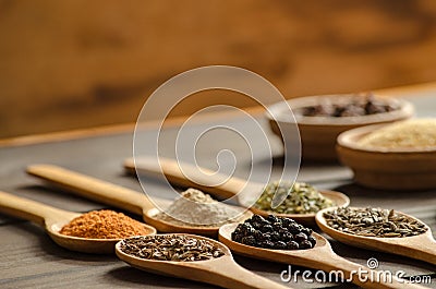 Aromatic colorful spices on wooden spoons Stock Photo