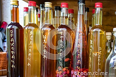 Aromatic home made and very healthy brandy Serbian Rakija with different herbs inside the bottle Editorial Stock Photo